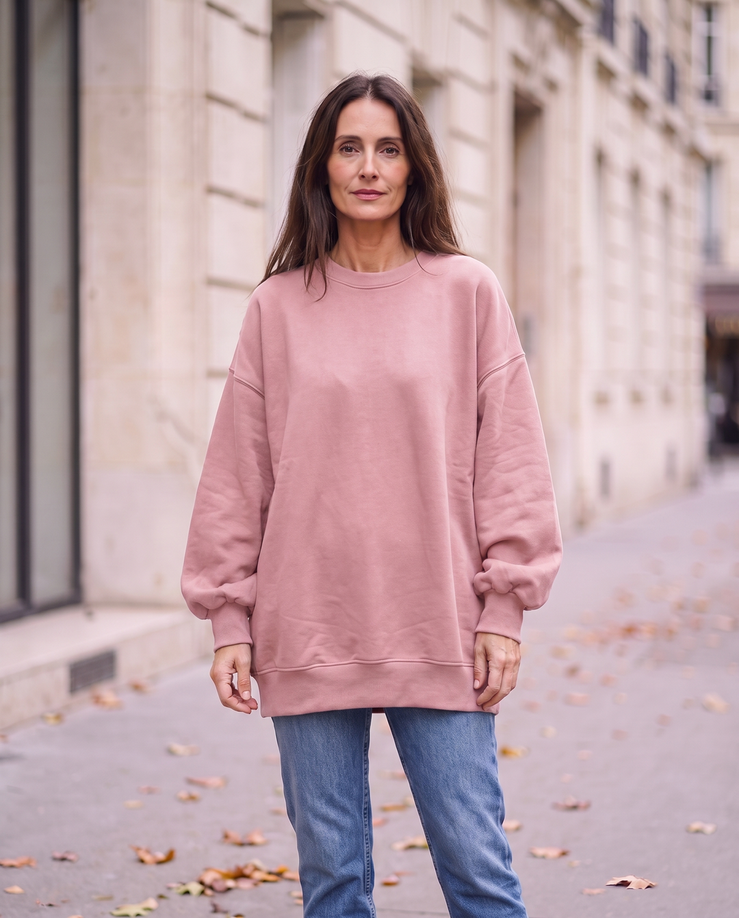 Kvinna i rosa oversized stickad tröja utan sidöppningar, framifrån